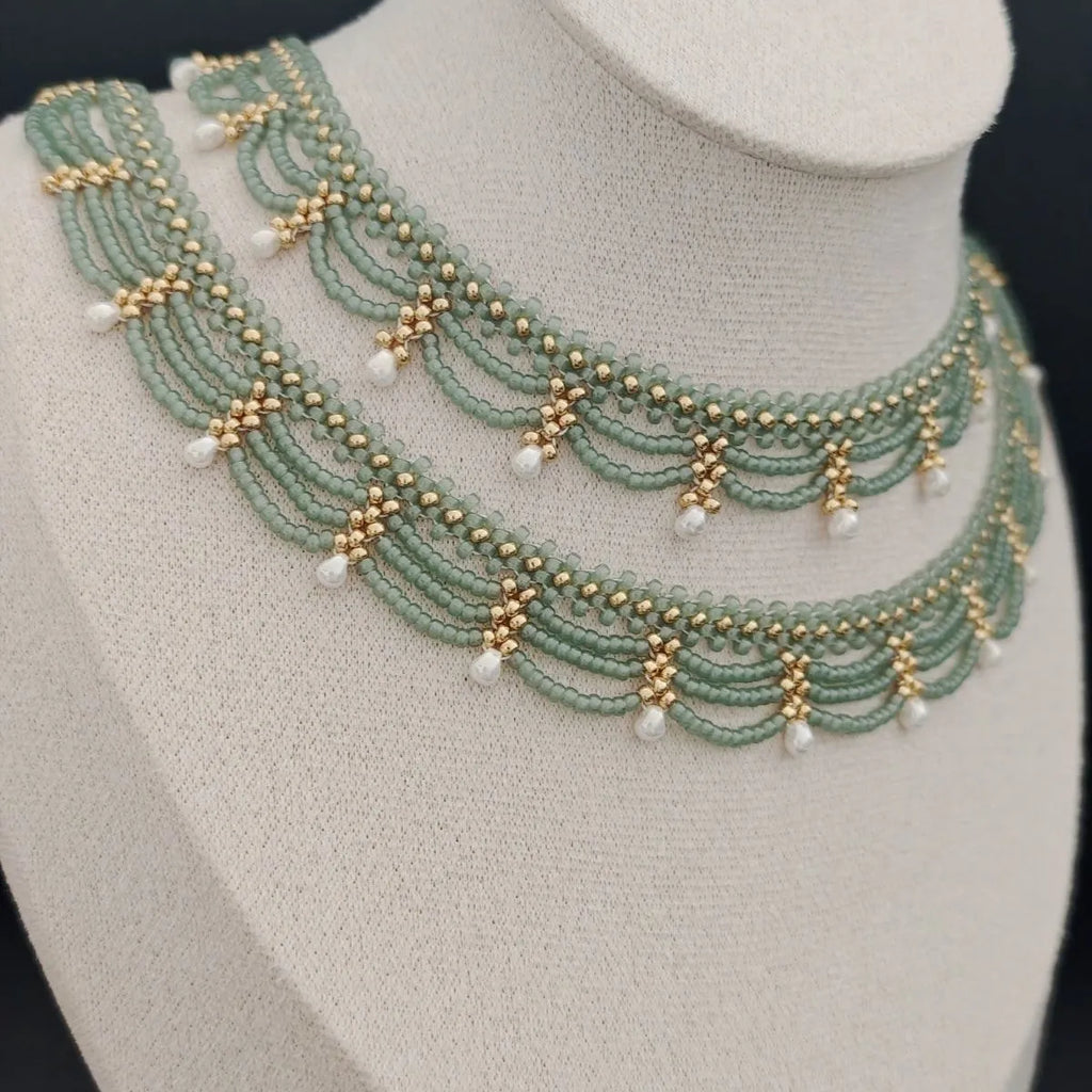 Retro style tassel water drop imitation pearl pendant necklace on display