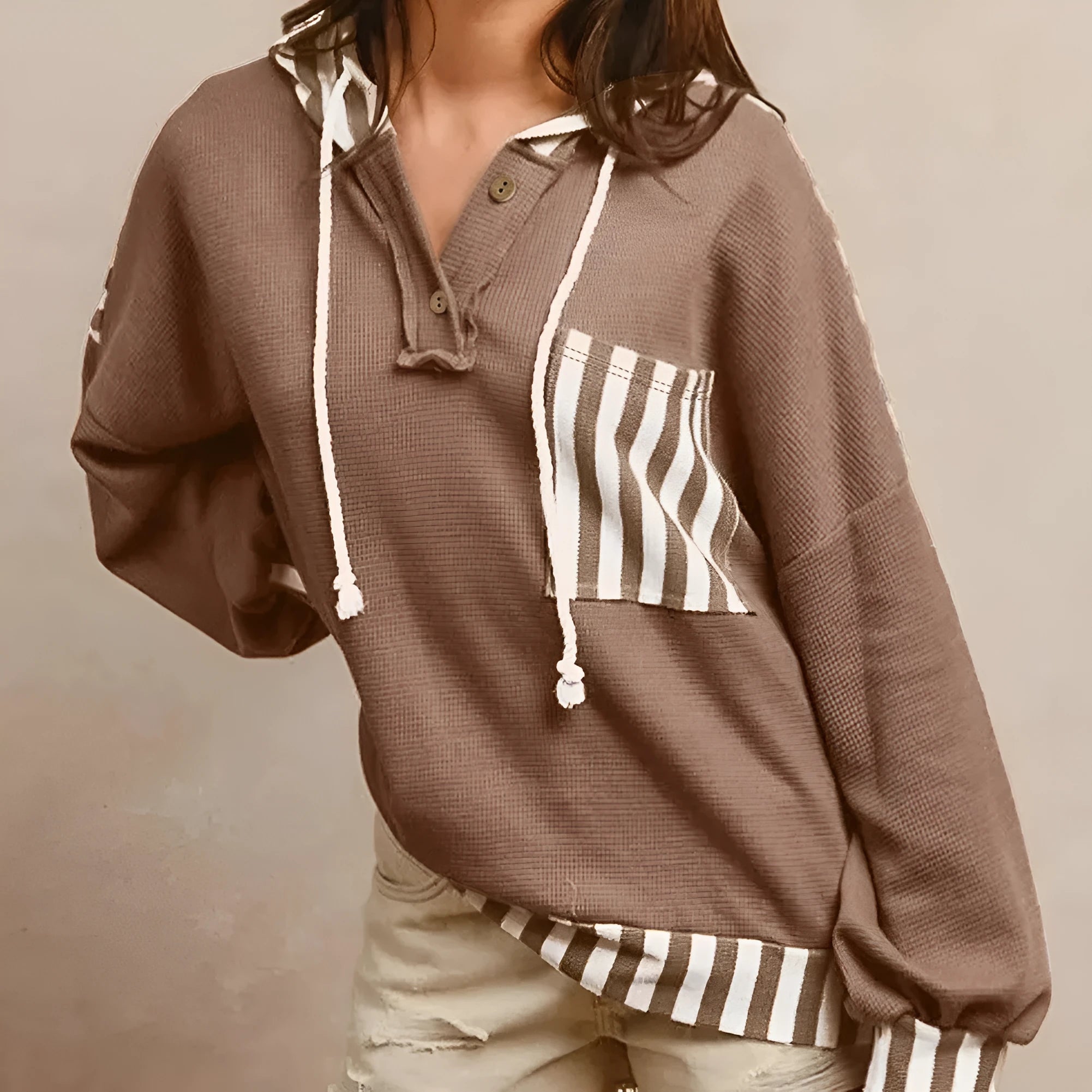 Straw yellow waffle texture hoodie with striped patchwork and a button-front drawstring neckline.