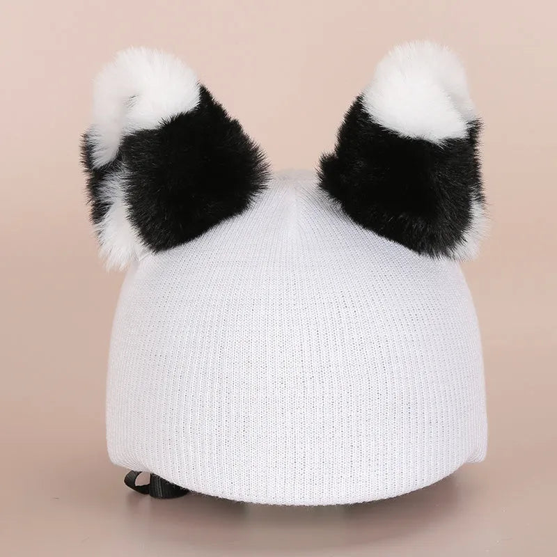 Plush fabric cartoon character decorative cover on a ski helmet.