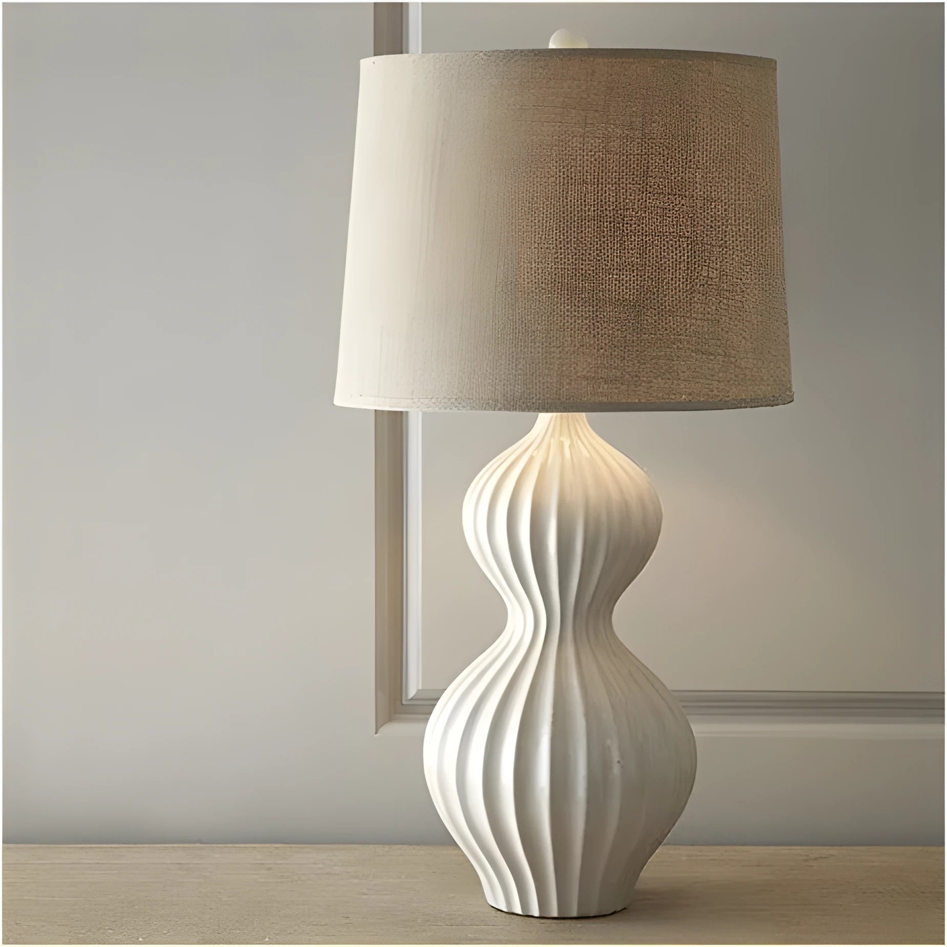Ceramic base table lamp with a white fabric shade in an American simple country style.