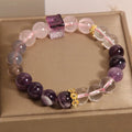 Close-up of a purple women's bracelet with 10mm amethyst crystal beads and rhinestone decoration on an adjustable strap.