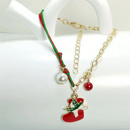 Christmas charm bracelet with snowman, Santa Claus, and snowflake designs