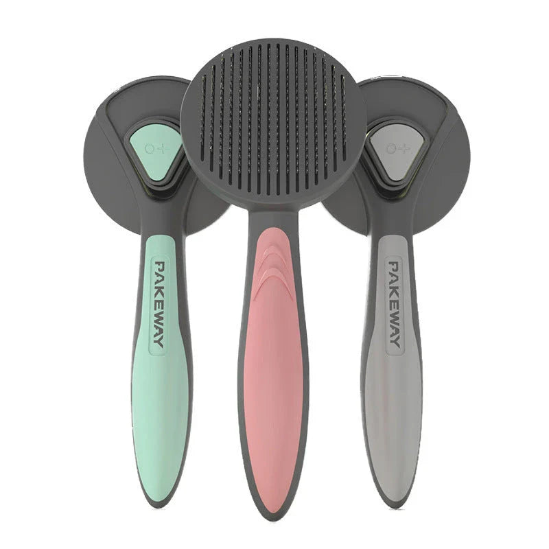 Ergonomic pet grooming brush in mint green, cherry blossom powder, and gentleman grey