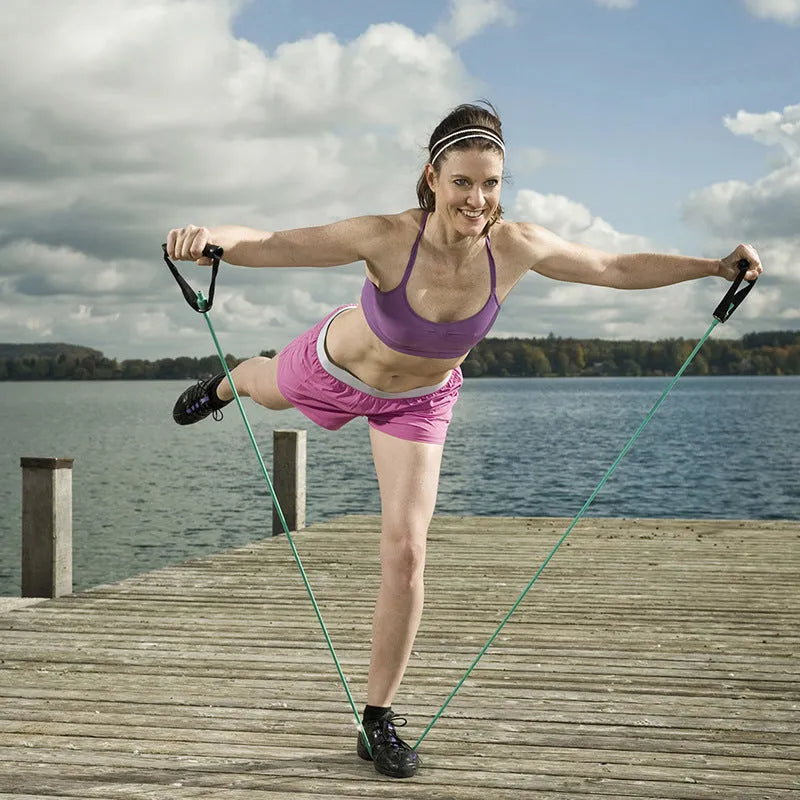 Five colour-coded latex resistance band pull ropes in black, blue, green, purple, red, and yellow on light background