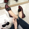 Women's patent leather pointed toe bowtie flats in black on a white background