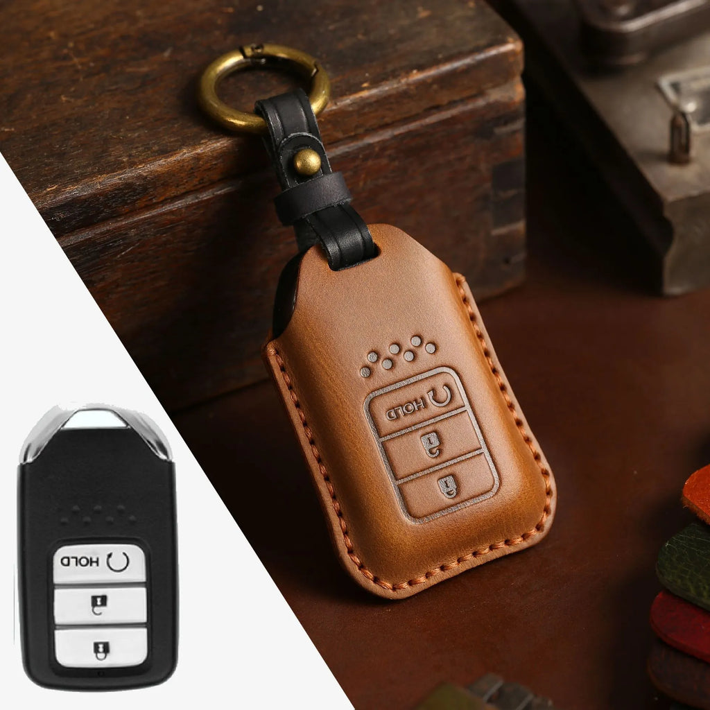 Full leather cowhide car key case in brown, three-button configuration, held in hand