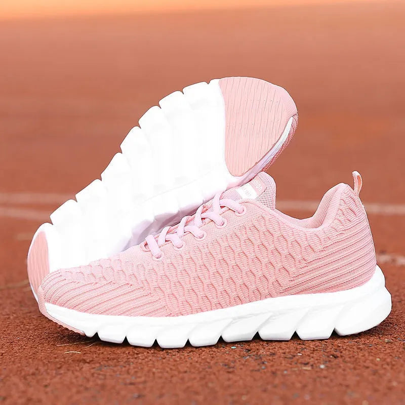 Women's running shoes in black with a fly weave upper and durable outsole.