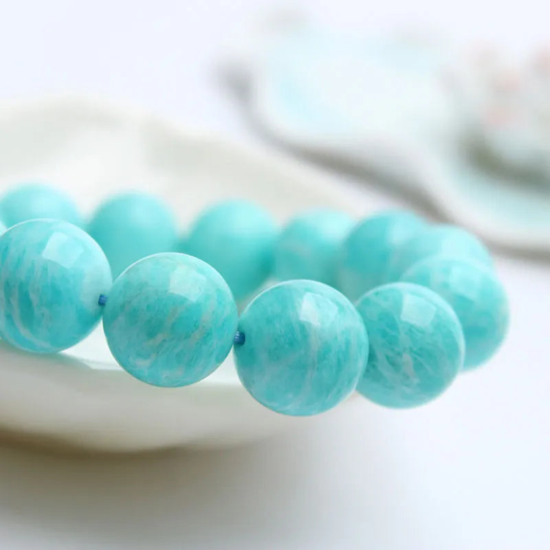Natural blue-green Amazonite stone bracelet with round beads on an adjustable cord.