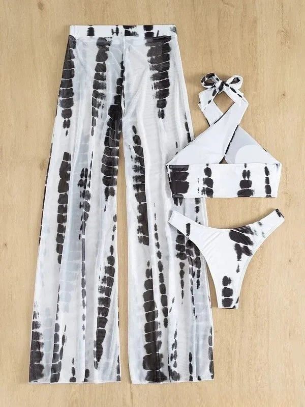 Women's three-piece swimsuit set with bikini top, bottom, and separate mesh trousers in a printed pattern.