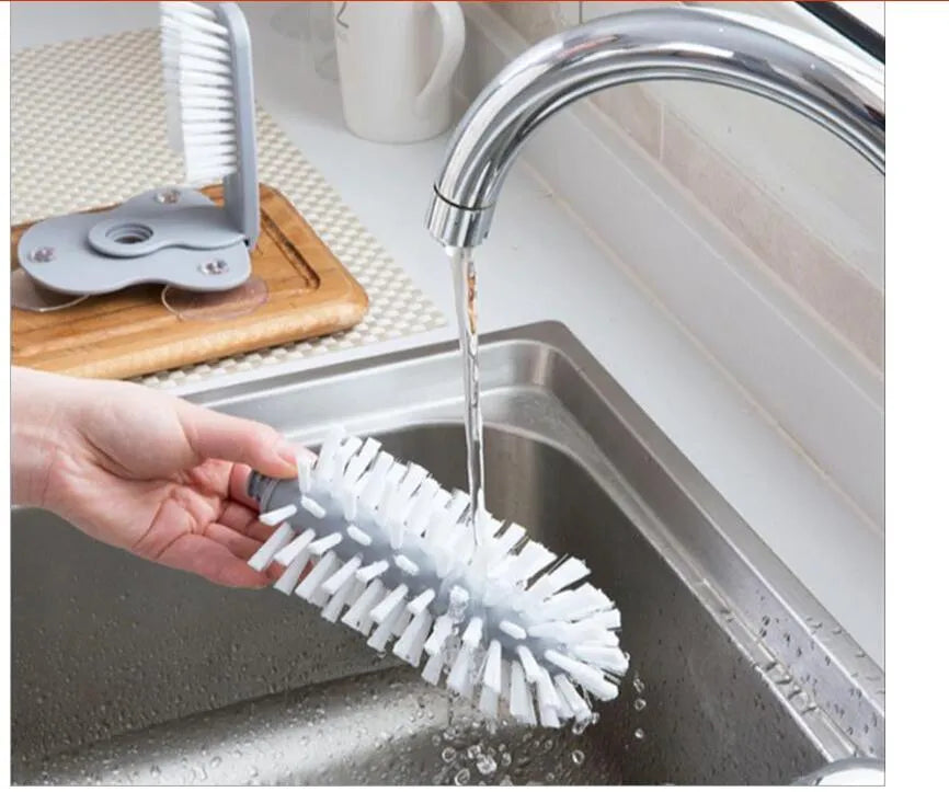 Grey double-headed cup cleaning brush with wall-mounted suction cups for kitchen use