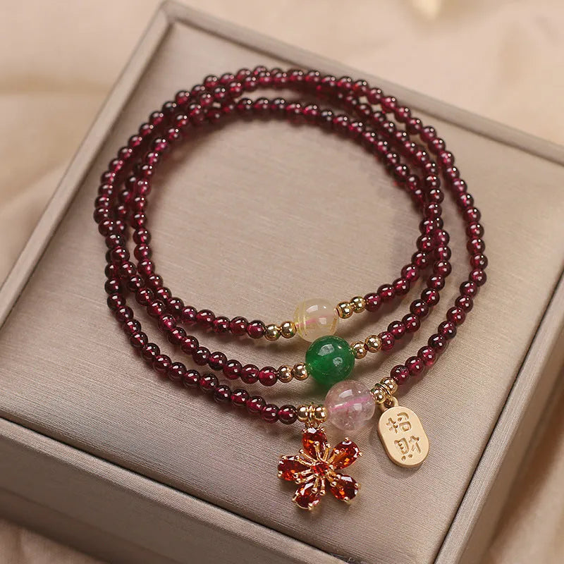 Natural crystal bracelet for women in pomegranate red cherry blossom colour with sequin detailing.