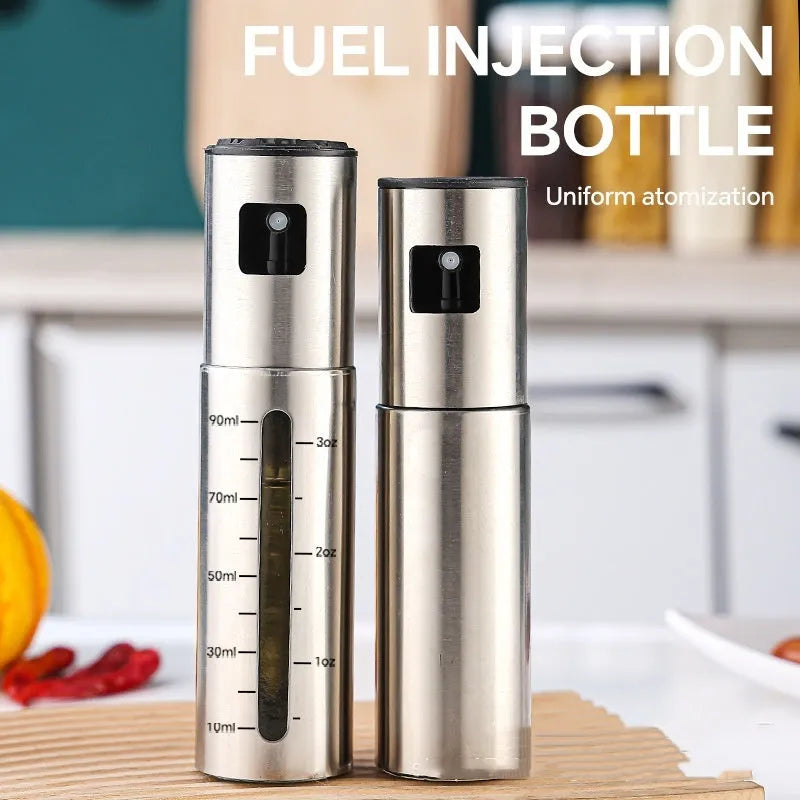 Stainless steel press-type oil injection bottle with 100ml capacity and glass body on kitchen counter
