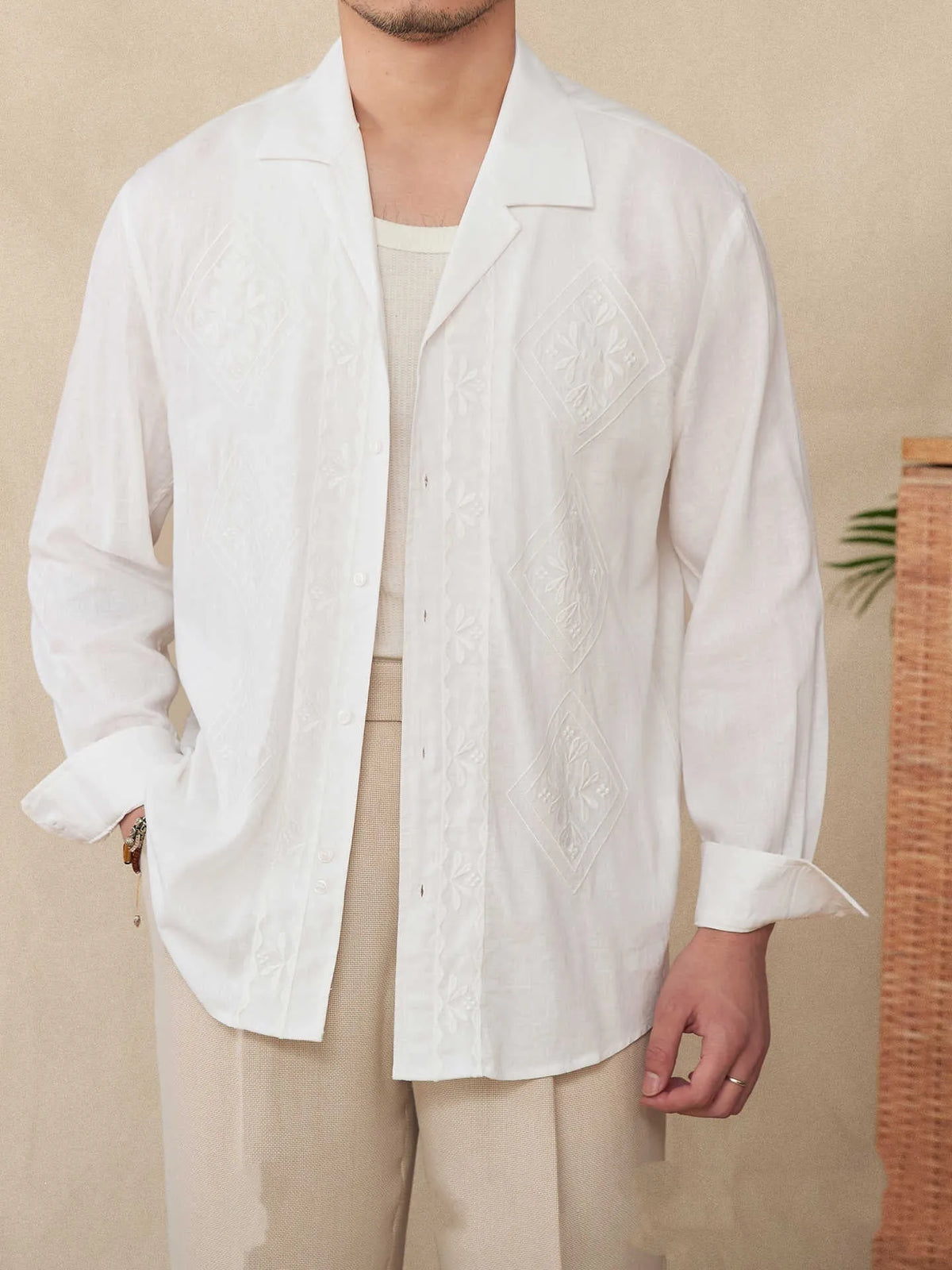Cotton and linen thin embroidery Cuban collar long sleeve sunscreen shirt in white on a plain background
