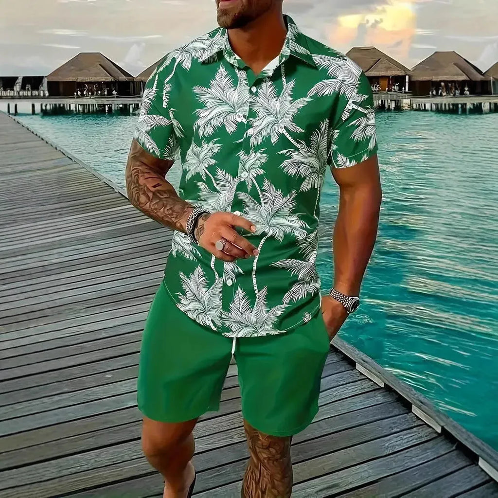 Man wearing a blue Hawaiian print short sleeve shirt and matching shorts from a casual suit set.