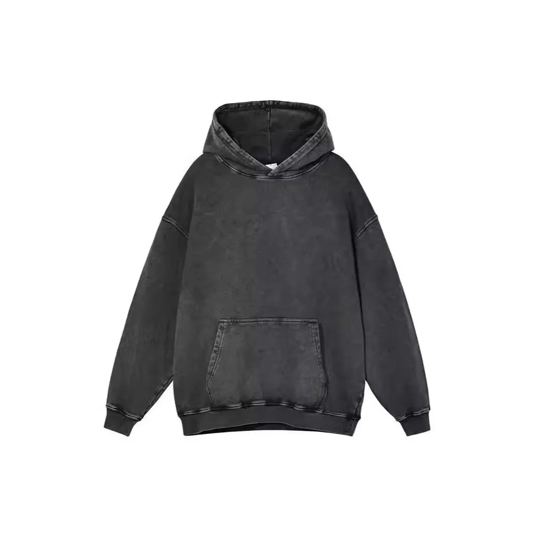 Man wearing a loose, brown, batik-washed cotton pullover hoodie with drop-shoulder sleeves.