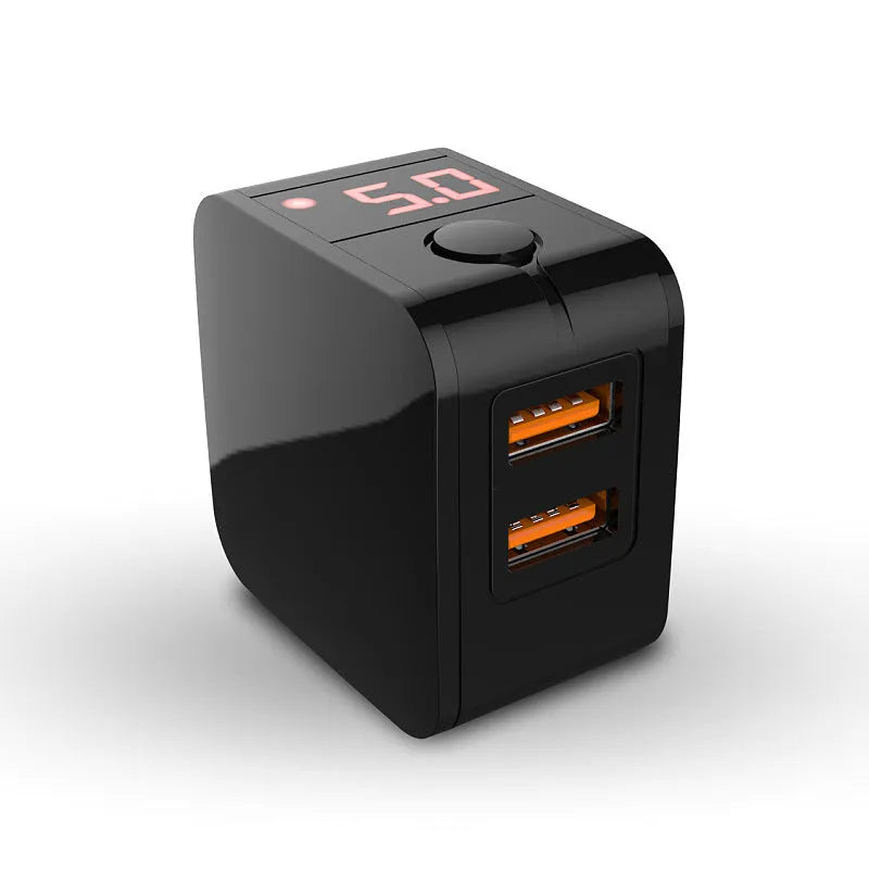 Black 5V 2.4A dual USB travel charger with digital display plugged into a wall socket.