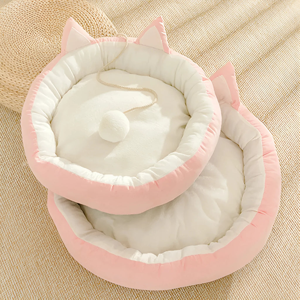 Round suede cat mat in pink grey with cat ear shape, 36cm diameter, on a light floor