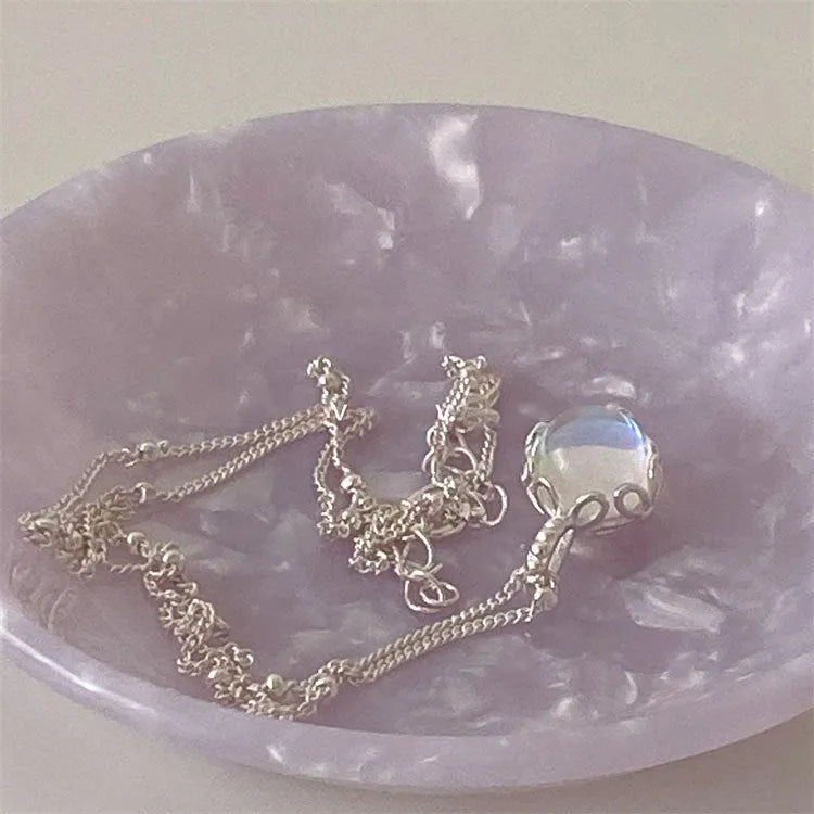 Geometric silver pendant on an adjustable 925 silver curb chain necklace.