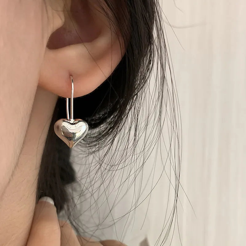 Korean-style silver heart earrings with three-dimensional design and glossy finish