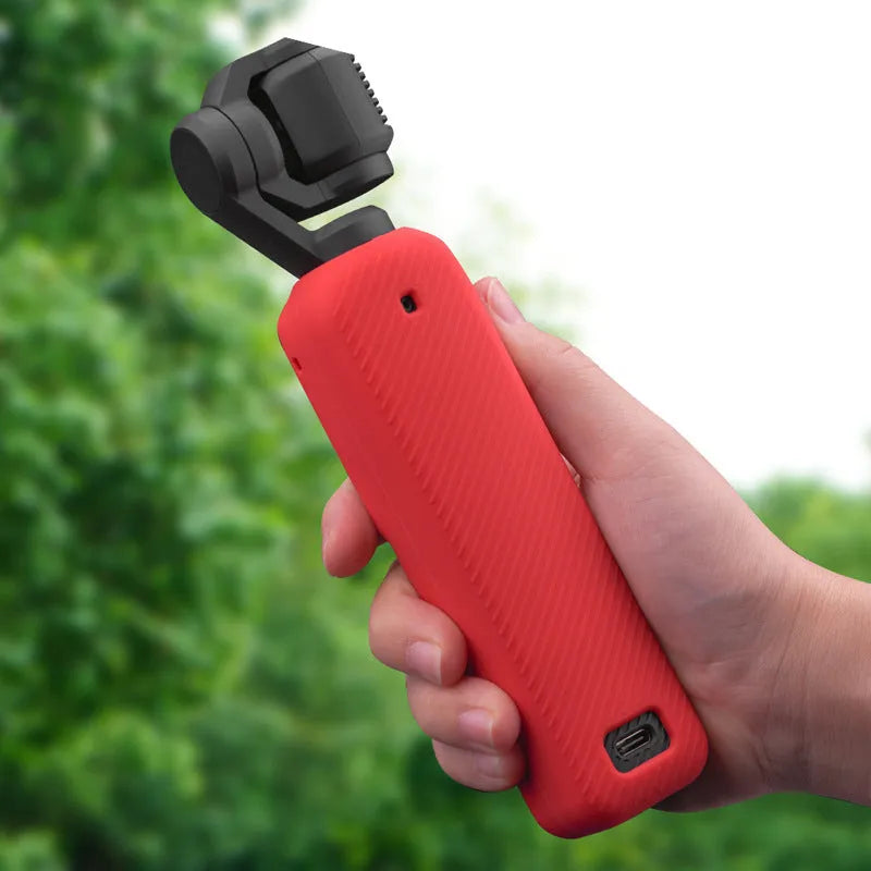 Silicone protective cover for camera body in black, red, and orange colours showing non-slip texture