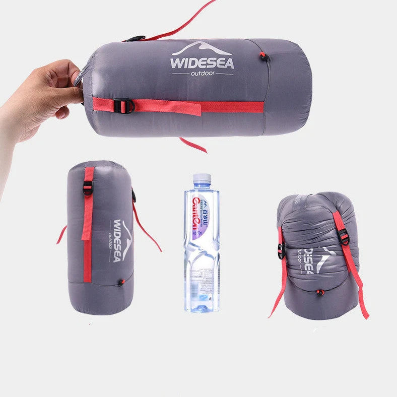 Cyan grey camping sleeping bag with compression sack showing 90% white duck down filling and waterproof nylon fabric