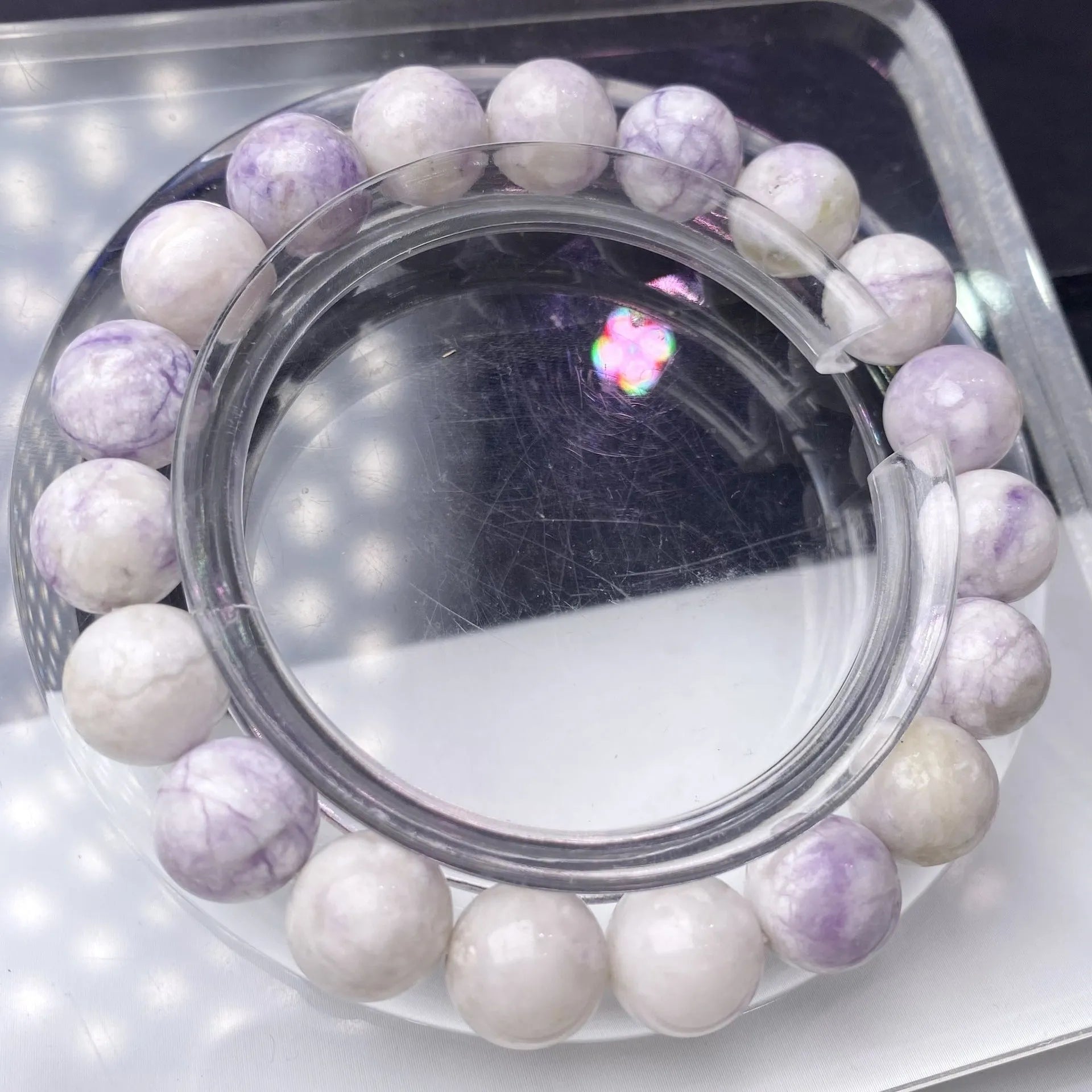Women's purple turquoise bracelet with natural gemstone beads on a wrist.