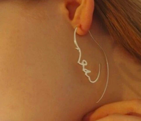 Abstract face contour earrings in gold and silver, 75mm x 35mm