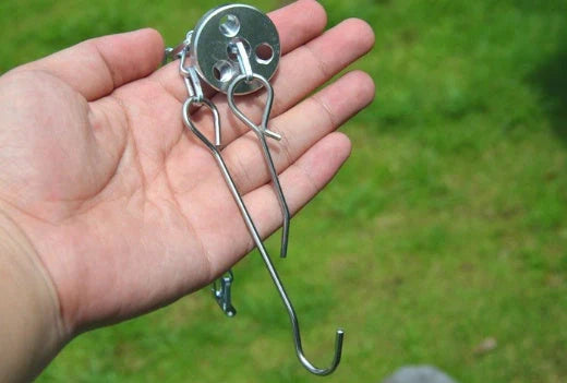 Silver aluminium camping tripod with hanging chain for outdoor barbecue cooking