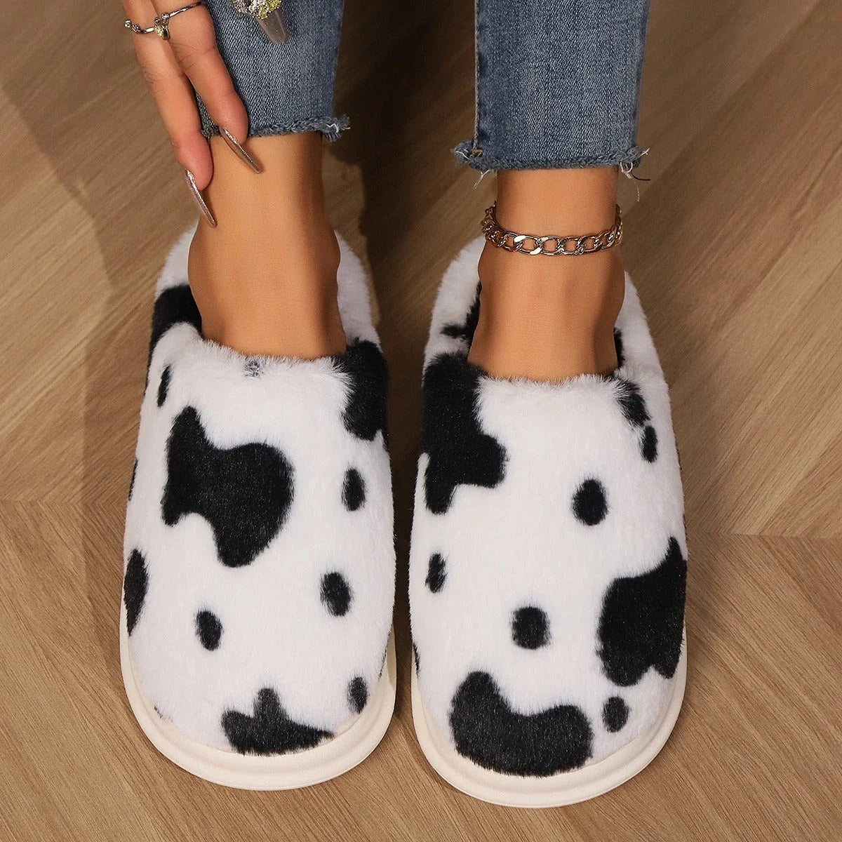 A pair of cozy, plush slippers with a unique spotted pattern, designed for warm and comfortable indoor wear.