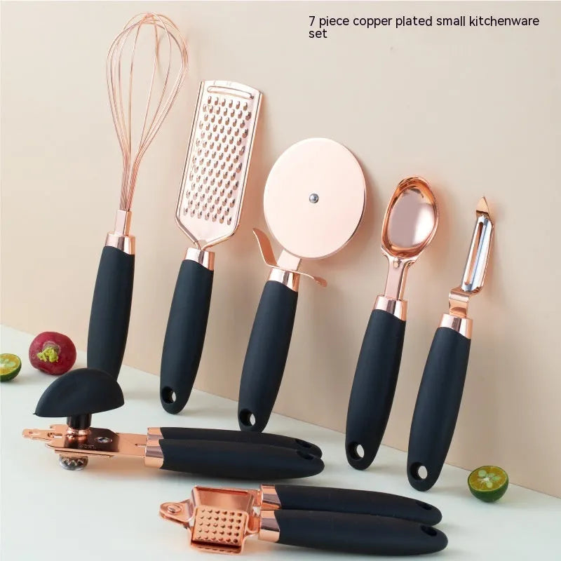 7-piece stainless steel kitchen tool set with copper plating in assorted colours on a countertop.
