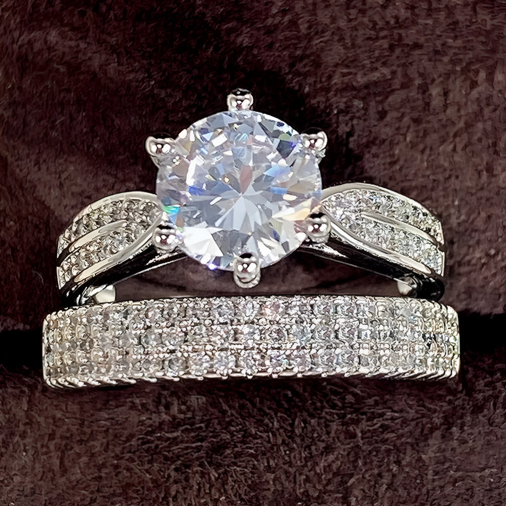 Geometric white gold colour alloy wedding ring on a finger, showing its round design.