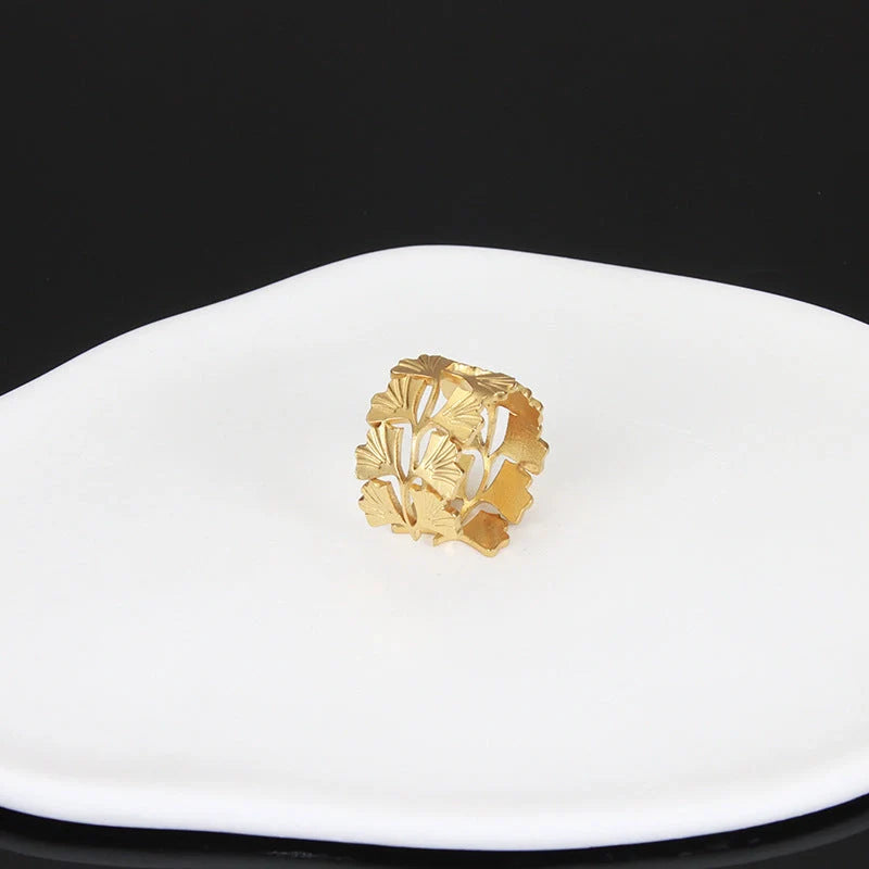 Adjustable stainless steel finger ring with unique charm designs in steel and gold colours