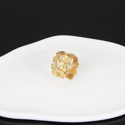 Adjustable stainless steel finger ring with unique charm designs in steel and gold colours