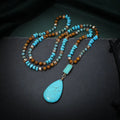 Turquoise water drop shaped pendant necklace with mixed gem inlaid detailing on ball bead chain