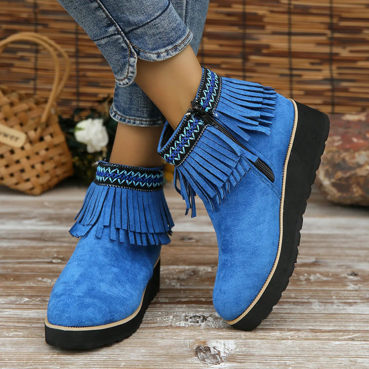 Women's black suede thick sole wedge ankle boots with side zip and tassel detail.