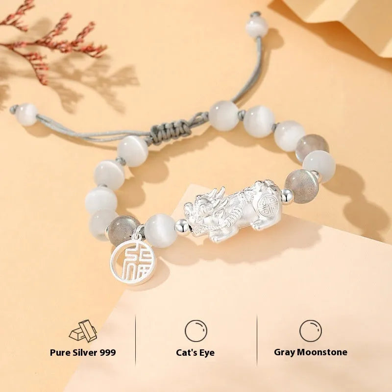 Sterling silver blessing card attached to a hand-woven black and white couple bracelet set with tassel details.