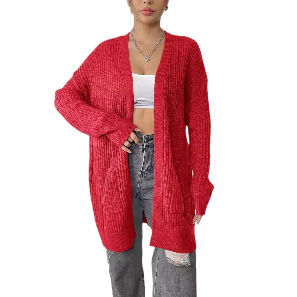 Women's dark green loose-fit acrylic cardigan sweater with double pockets and long sleeves.