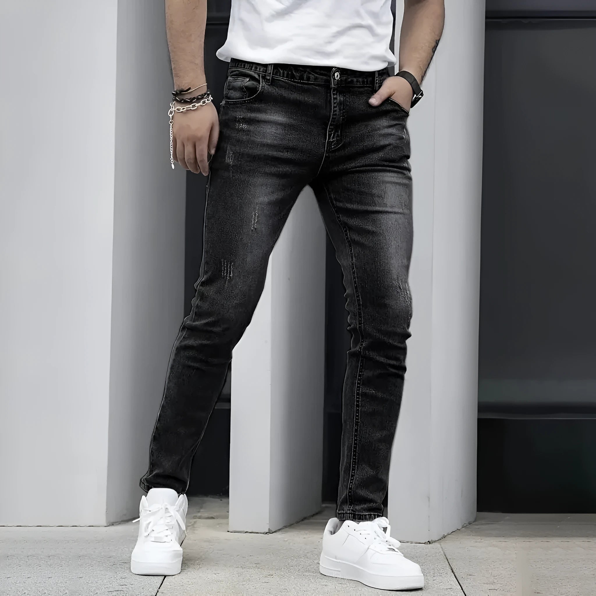 Men's black stretch jeans with straight leg and skinny opening, laid flat.