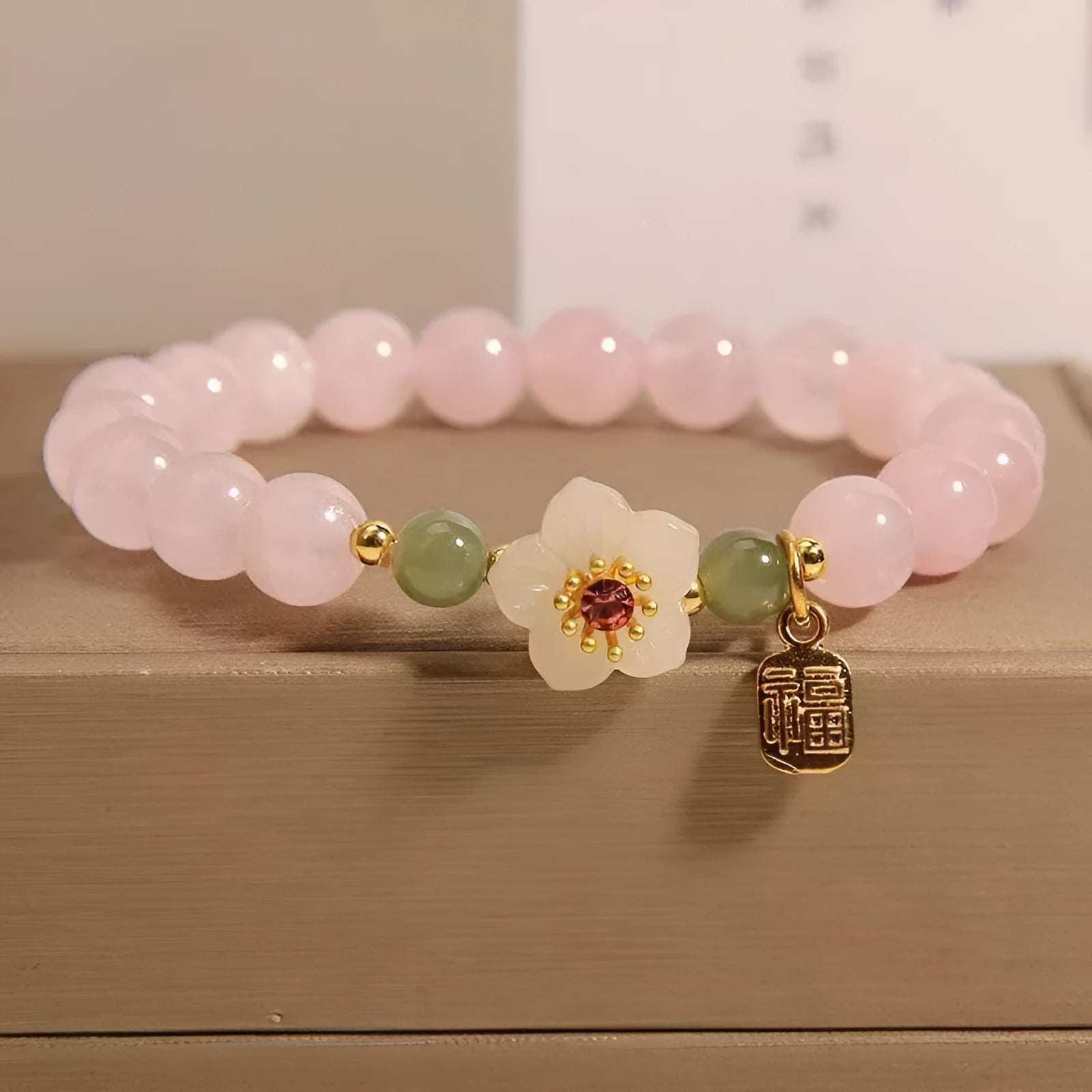 Crystal Hetian Jade bracelet with camellia fruit-shaped charms in pastoral style design