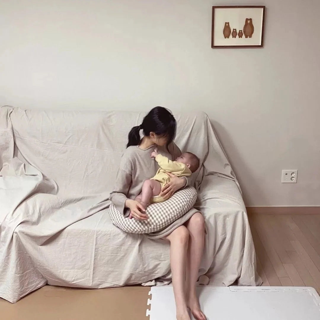 Moon-shaped baby nursing pillow in plaid cotton for newborns, available in yellow, green, and brown