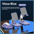 Q7 weighted portable folding desktop stand in four colour options holding mobile phone