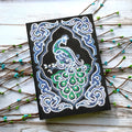 Black A5 diamond painting notebook with peacock design using shaped and bright drills.