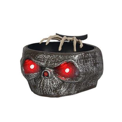 Motion-activated Halloween pumpkin candy bowl with spooky skeleton hand and glowing red eyes
