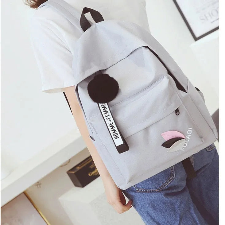 College style canvas rucksack in green with leaf pattern, showing anti-theft features and shoulder straps