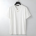 A woman's loose-fitting apricot-coloured V-neck short sleeve cotton top laid flat.