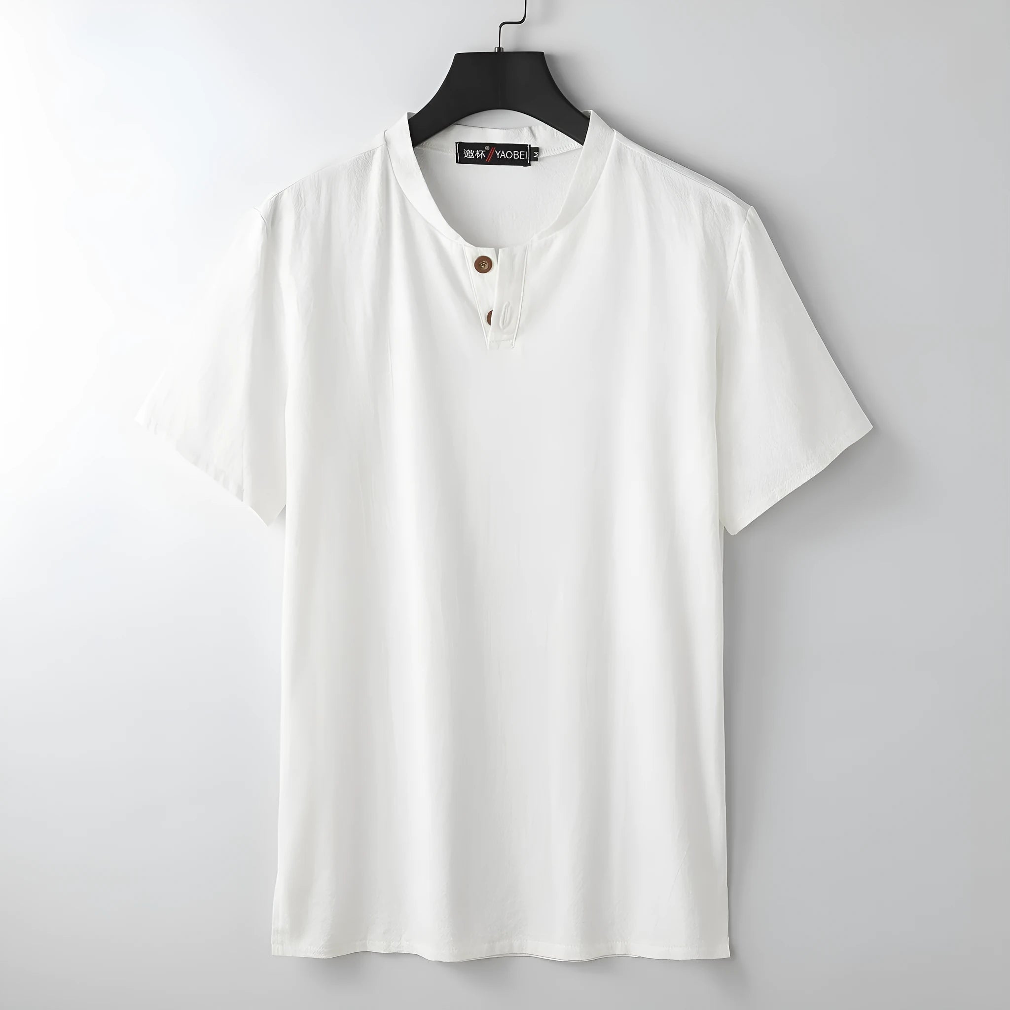 A woman's loose-fitting apricot-coloured V-neck short sleeve cotton top laid flat.
