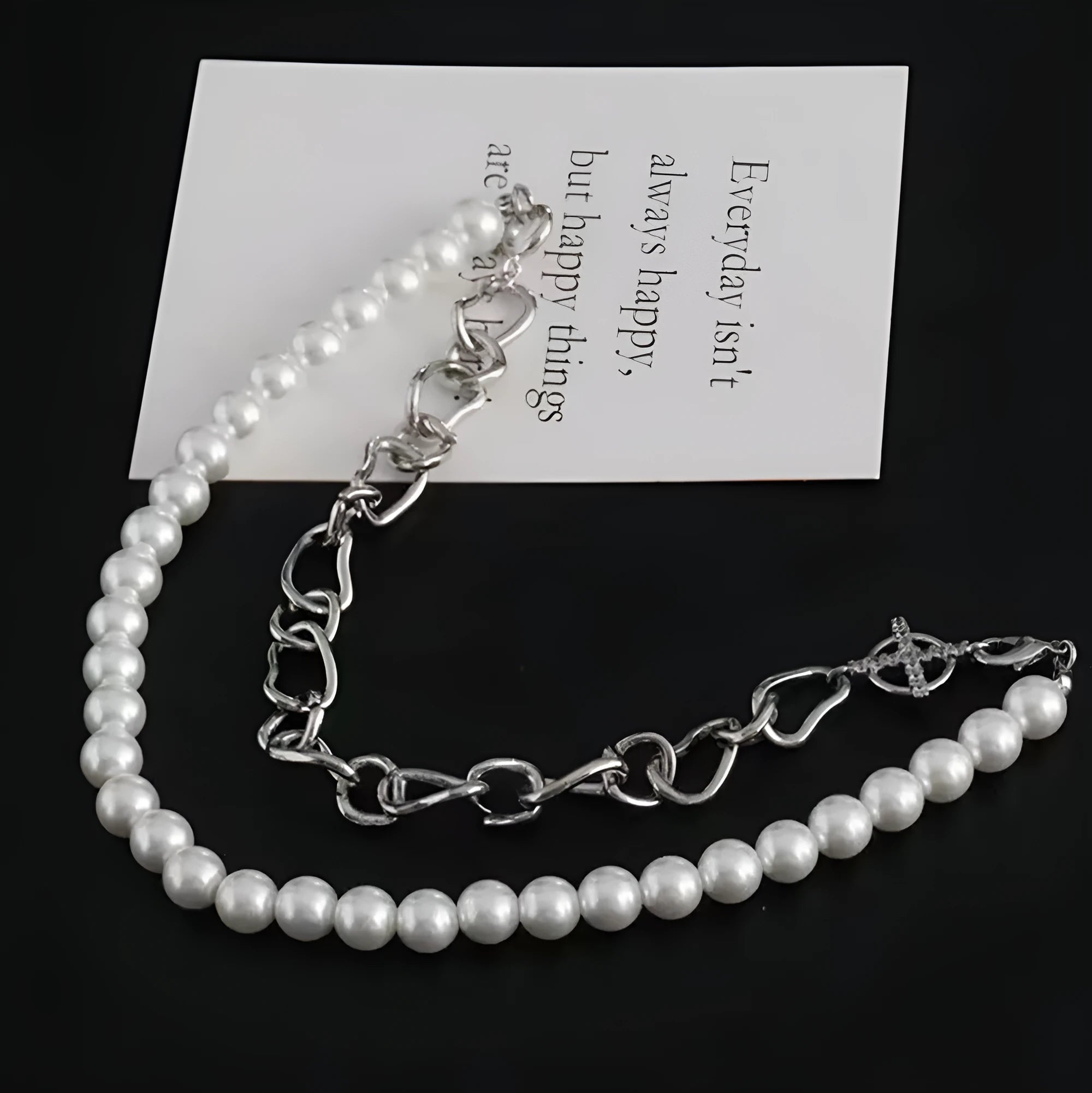 White geometric asymmetric acrylic pendant necklace on a twisted chain.