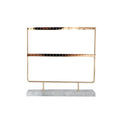 Alloy earring storage rack in green holding stud and drop earrings on a desktop