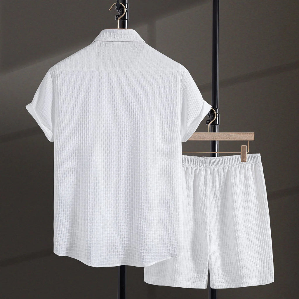 Men's black cotton blend short sleeve shirt and matching shorts casual suit laid flat.