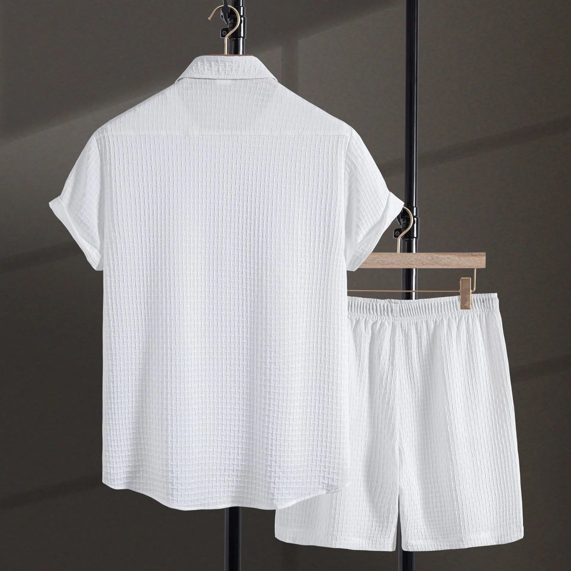 Men's black cotton blend short sleeve shirt and matching shorts casual suit laid flat.